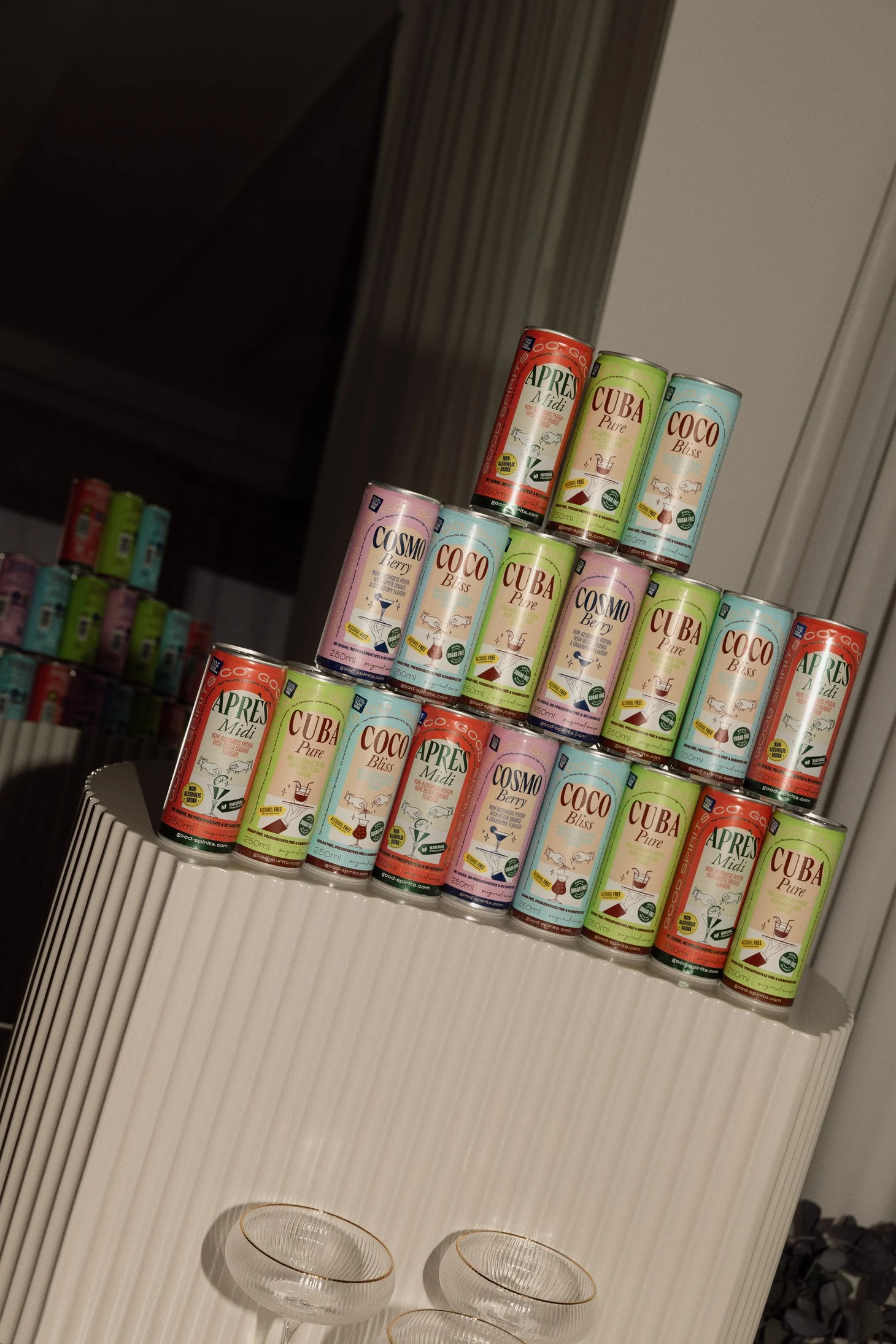 A pyramid of Good Spirits Co. mocktail cans on a fluted plinth