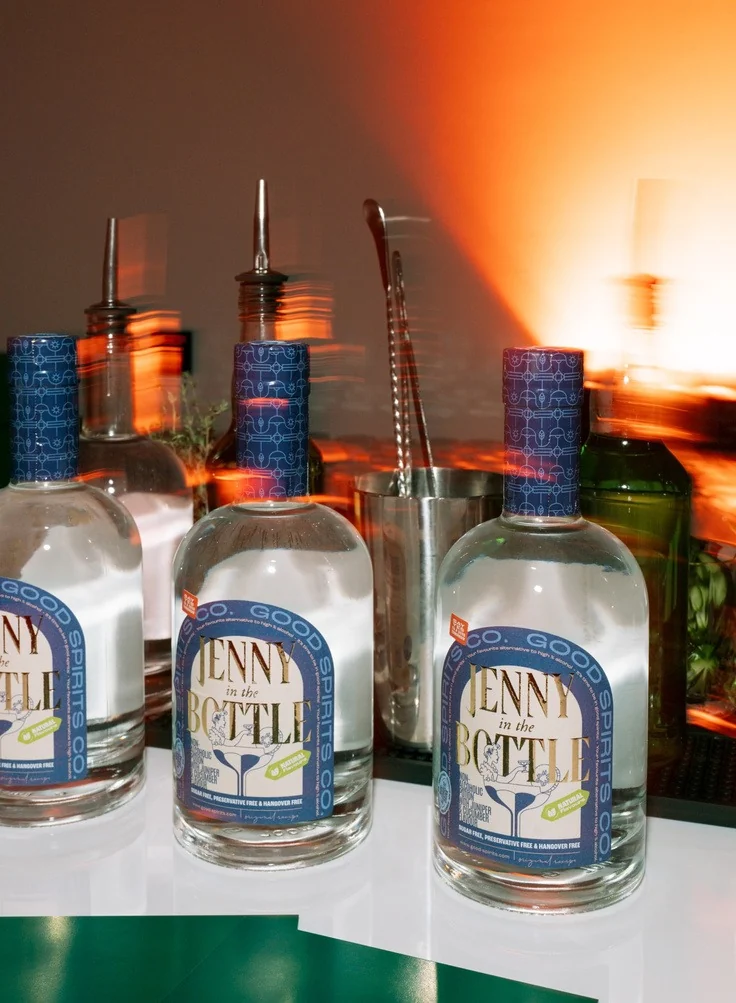 Bottles of Jenny in the Bottle set up on a back bar